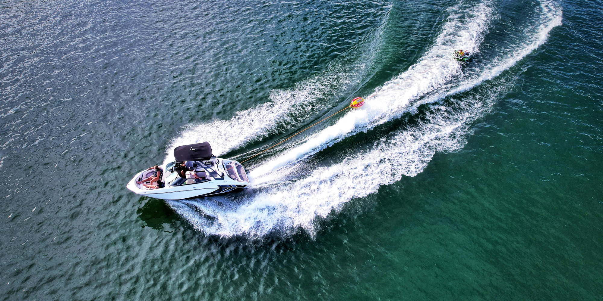 Boat pulling a tube